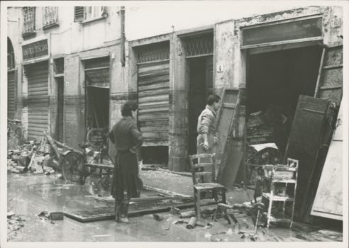 Couple cleaning their shop near &quot;Tintoria Toscana&quot;