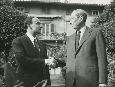 Millard Meiss shakes hands with a representative from Encyclopedia Britannica