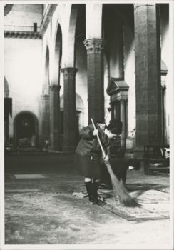 Woman cleans the interior of Santa Croce