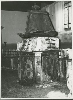 Damaged wooden lectern with flooded papers