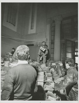 Volunteers  moving damaged books inside the Biblioteca Nazionale